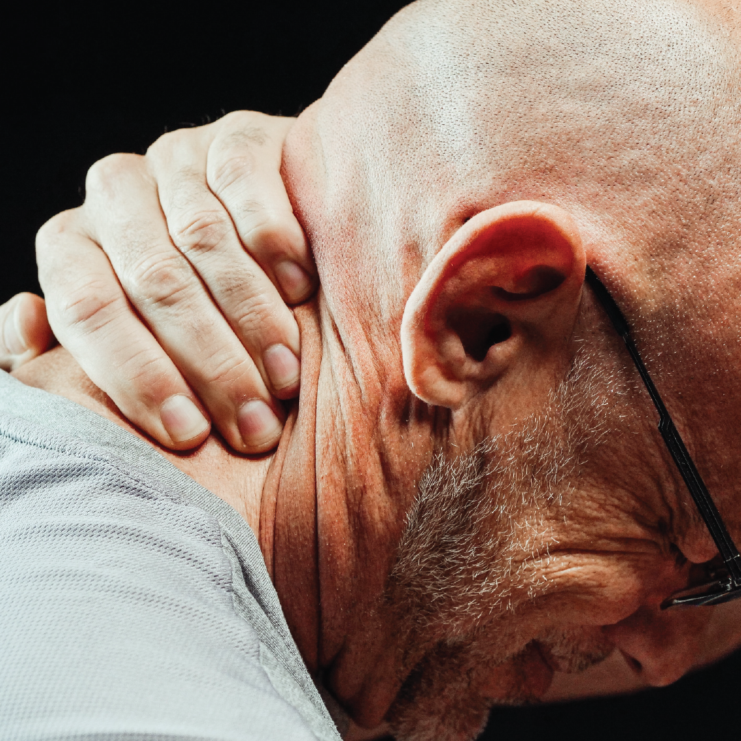 man holding his neck in pain